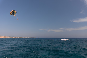 parasailing. the man is flying with a yellow parachute. close-up.