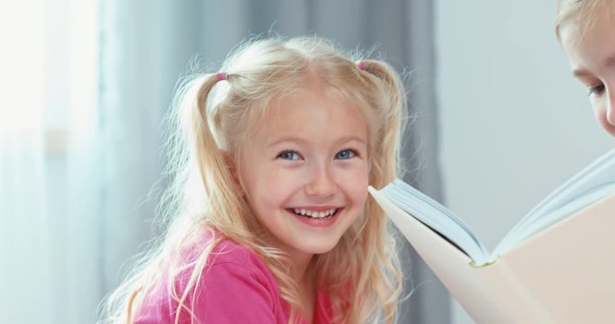 Portrait two blonde sisters have a good time together