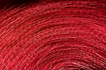 Abstract Texture from the red abstract  lines from bright night fires twirled in a circle against a dark background. Motion blur