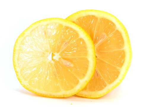 Half and one slice of lemon close-up isolated on white background