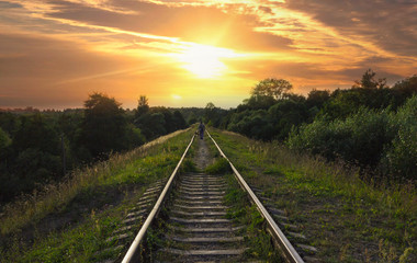 Man with dog is walking on the railroad