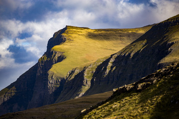 Green Mountain cliffs in Faroe islands on a sunny day
