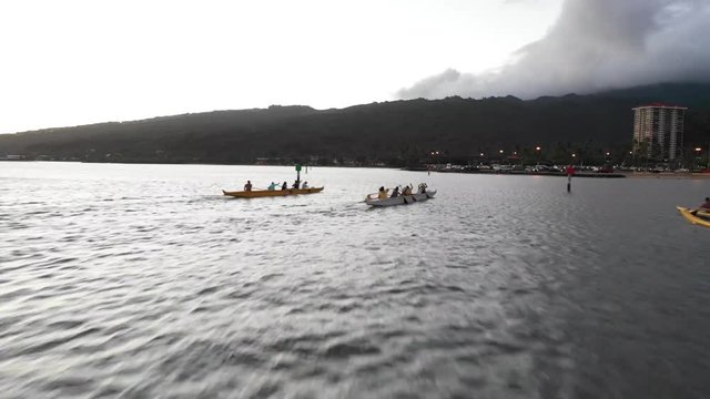Sunset on the coast of Honolulu in Hawaii. Boats, Jets Skis, and Cars