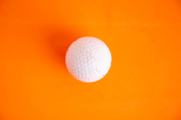golf ball on orange background