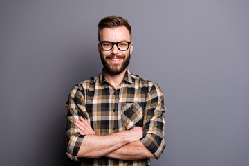 Fototapeta premium Young handsome man in spectacles and brown checkered shirt look 