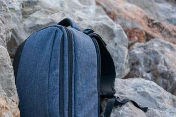 Close up of backpack on stone background, space for text. Adventure traveler concept, sport...