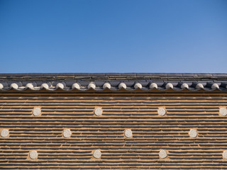 Asaian traditional village fence and blue sky on the background, South Korea