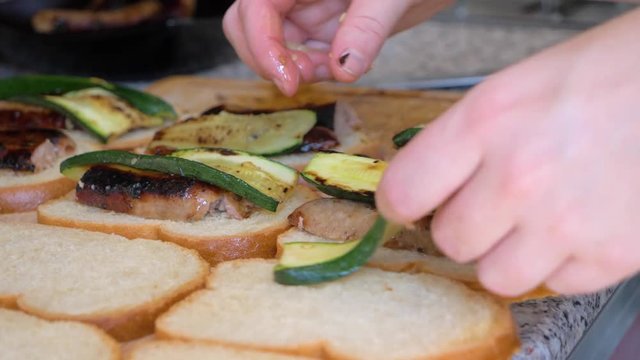 Cook Who Prepares Croque Monsieur With Vegetables in slowmotion in a french food truck.