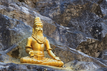 Buddhist golden statue man meditating