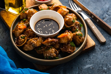 Fried dumplings with soy sauce with pepper and green onions. Asian cuisine