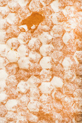 Natural golden bee honeycomb texture, wallpaper or background, close-up, vertical composition