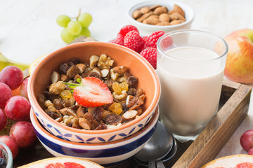 Gluten frHealthy eating, paleo gluten free nut and fruit granola served with fruits and berries, nut milk, selective focusee paleo nut granola