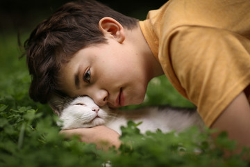 teenager boy with cat in hummock nap