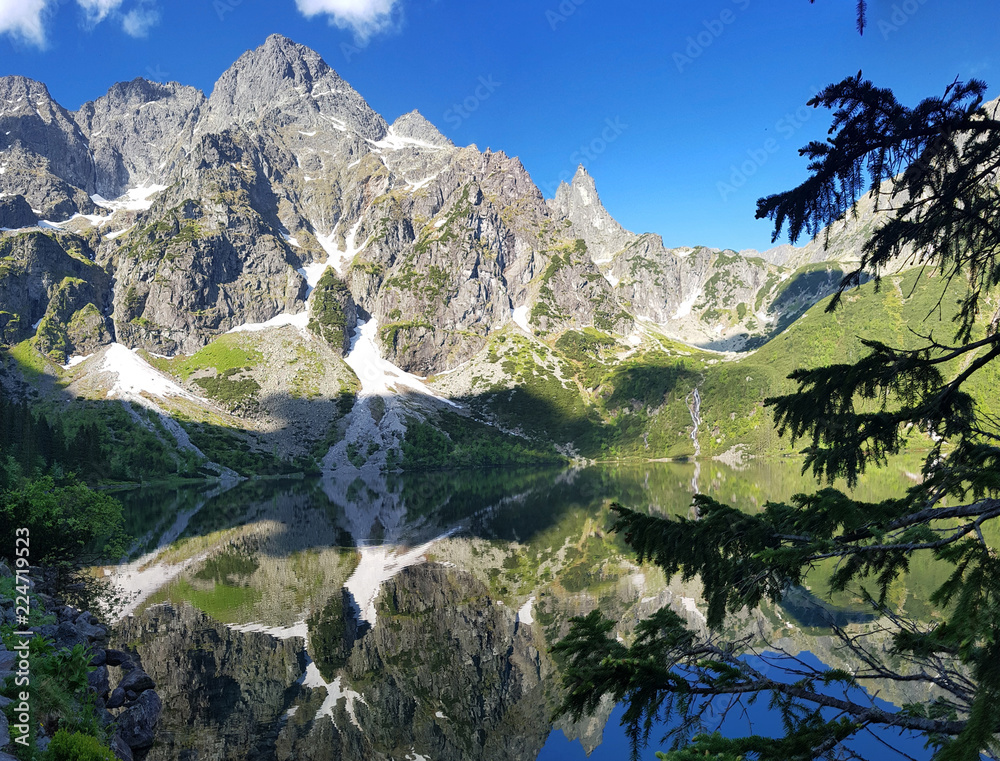 Wall mural morskie oko. high tatras, poland, may 27, 2018. beautiful landscape of snowy mountain tops and the l