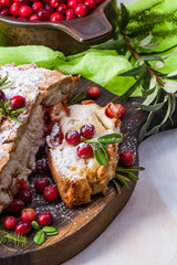 Delicious cranberry pie with fresh cranberries and herbs for Christmas on wooden plate