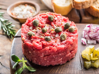 Steak tartare served with capers, pickled cucumbers and chopped onion.