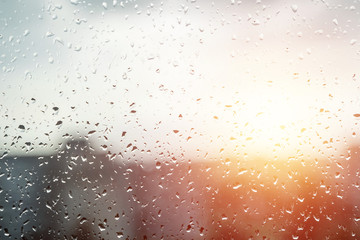 Creative background, drops on the glass, rain, view from the window in rainy weather. The concept...