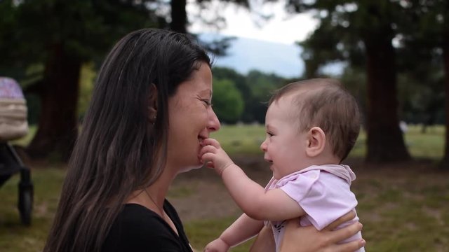 A baby developing senses by touching its mother&not;&yen;s month