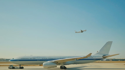Passenger plane fly up over take-off runway from airport.
