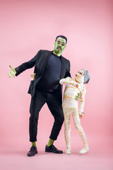 Halloween Family. Happy Father and Children Girl in Halloween Costume and Makeup. Bloody theme: the...