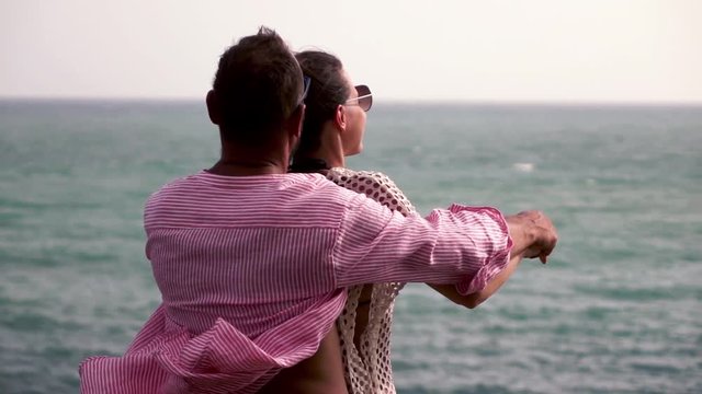 Young, couple standing in titanic pose and enjoying beautiful sea view, 240fps
