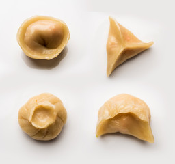 Dumpling momos food from Nepal or Ladakh served with red chilli chutney over moody background. Selective focus