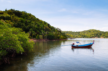 Fototapeta na wymiar Thai Longtail Fishing Boat at Koh Tean mangrove forest near Samui island in summer day with blue sky