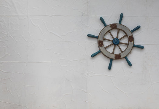 Vintage wooden ship's wheel on white background