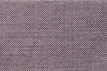 Brown textile background with chess pattern, closeup. Structure of the fabric macro.