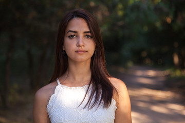Fototapeta premium serious cute woman standing in the green park