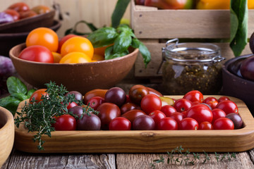 Colorful vegetables on rural wooden table, bell peppers, eggplants and tomatoes