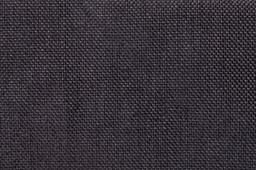 Dark brown background of dense woven bagging fabric, closeup. Structure of the textile macro.