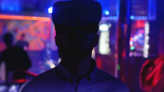 Young man in head-mounted display looks around, virtual reality, hmd 360