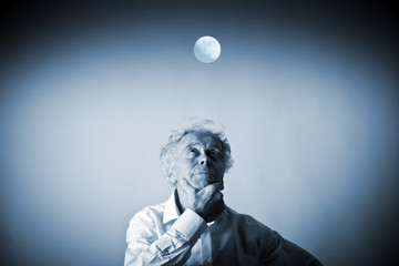 Old man in thoughts. Old man in white and full moon. Sleeplessness.