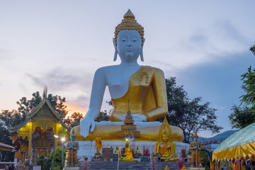 Fototapeta premium Pagoda stupa at Wat-Pratatdoikham (temple name), Chiangmai, Thailand - Buddha statue for praying and worship in Buddhist.