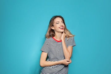 Obraz premium Beautiful young woman with healthy long blonde hair on color background