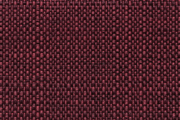 Dark red textile background with checkered pattern, closeup. Structure of the fabric macro.