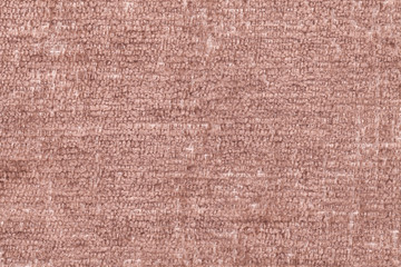 Fototapeta na wymiar Brown fluffy background of soft, fleecy cloth. Texture of textile closeup