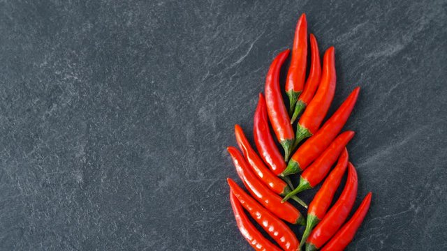 cooking, food and culinary concept - red chili or cayenne pepper on stone surface