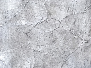 Texture decorative silver plaster imitating the old peeling wall.