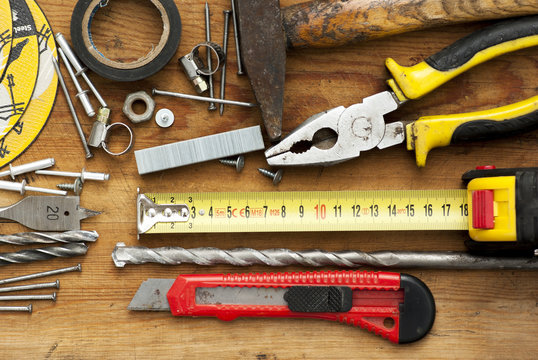 Building implements set for repair on wooden background top view.