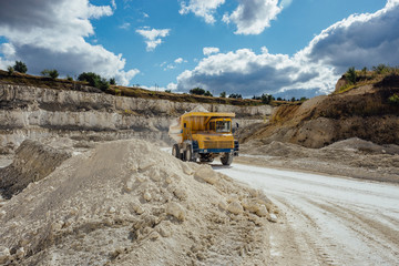 Chalk quarry. Moving dump truck loaded with chalk 