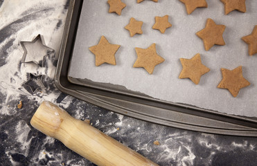 Gingerbread Cookies Being Rolled Out and Cut into Stars