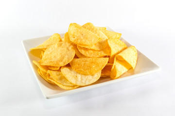 Close up potato chips on white dish