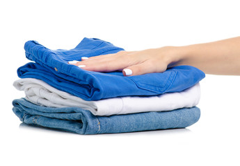 A stack of jeans clothes in hand on a white background isolation