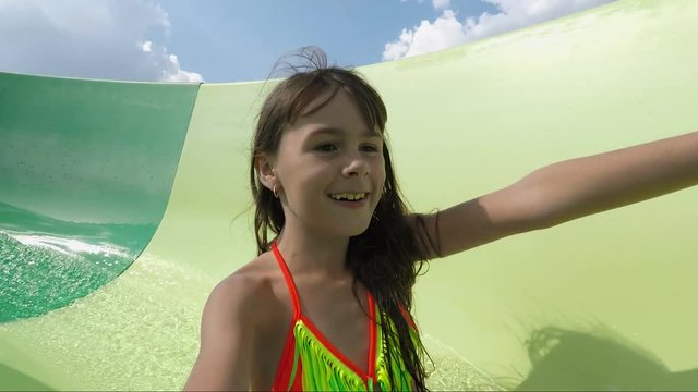 In the water park on the slides. Child on the water slides. Little girl in the water park.