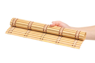 Bamboo mat natural in hand on a white background isolation
