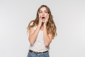 Wow. Beautiful female half-length front portrait isolated on studio backgroud. Young emotional surprised woman standing with open mouth. Human emotions, facial expression concept. Trendy colors