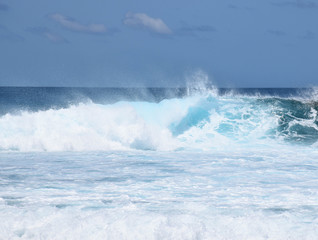 Huge waves crashing down into a frothy ocean, Pasta Point, Maldives.