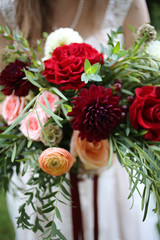 Bride Holding a Bouquet of Red, Maroon, Pink, Peach, and Yellow Flowers - Ranunculus, Roses, Dahlias